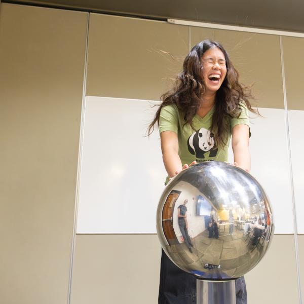 SAGE campers have fun experimenting with a Van de Graff generator