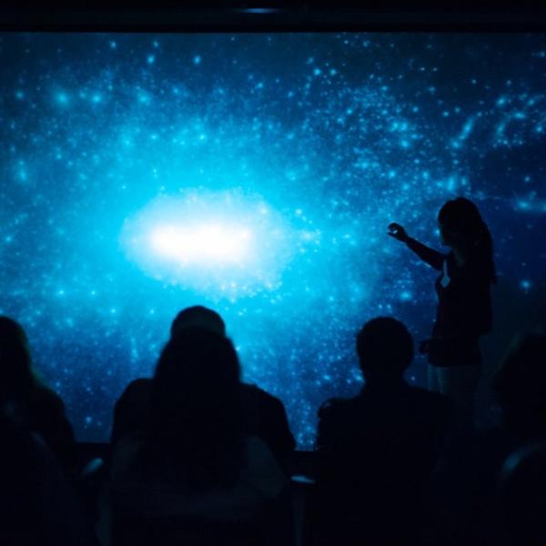 Photo - Student's silhouette against a projection screen.